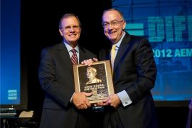 Deere & Company chairman and CEO Sam Allen accepts the AEM Hall of Fame plaque from 2012 chair of the AEM and CEO of Krone, North America, Rusty Fowler.