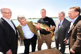 Brian Denney, CEO of Toronto and Region Conservation, Nicola Kettlitz, President, Coca-Cola Ltd., Rick Portiss, Manager, Restoration and Environmental Monitoring, Toronto and Region Conservation, Hon. Jim Bradley, Minister of the Environment, Government of Ontario and John Guarino, President, Coca-Cola Refreshments Canada with their big catch at Tommy Thompson Park on the Leslie Street Spit. Toronto and Region Conservation and Coca-Cola Canada have partnered to restore nine hectares of the Park into a flourishing coastal wetland. CNW