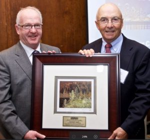 Past OHMPA President Doug Woods (2005) hands Raymond F. Legault, owner of Canadian Asphalt Industries Inc., OHMPA's 2016 Honorary Life Membership Award.