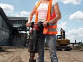 Female construction worker with machinery