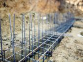 Foundation site of new building, details and reinforcements with steel bars and wire rod, preparing for cement pouring