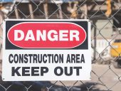 Danger construction area sign in front of demolition