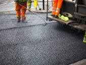a roadworks on the street new asphalt with worker