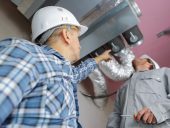 men setting up ventilation system indoors