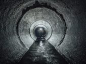 1871714 Underground river flowing in round concrete sewer tunnel. Sewage collector