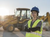 Worker woman looking at camera after working in sunset image