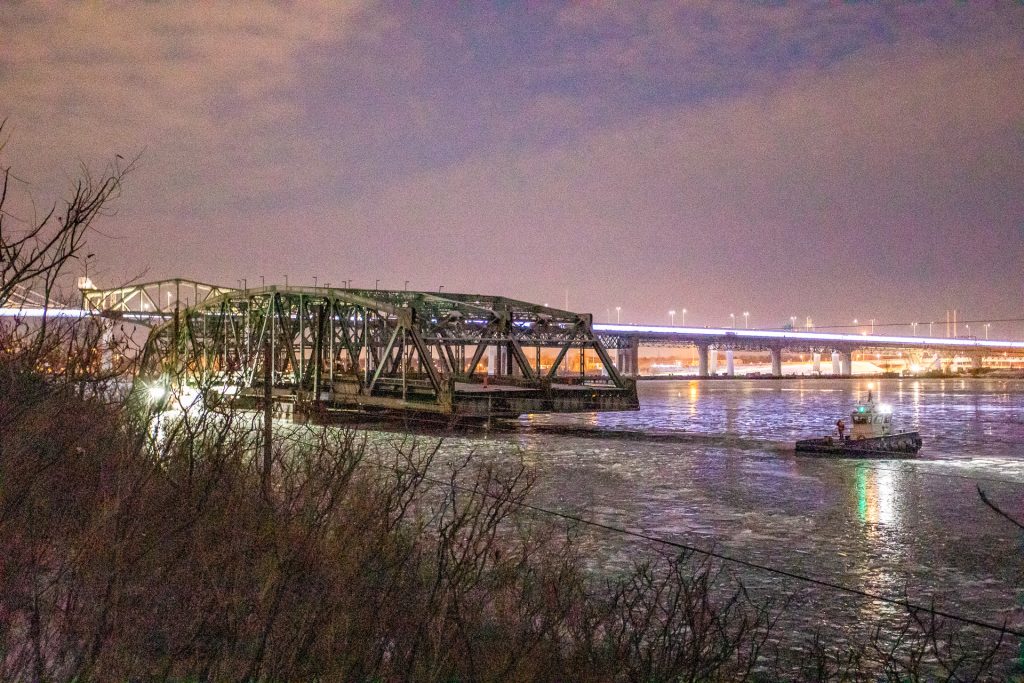 The main steel span of Montreal’s original Champlain Bridge over the St. Lawrence River was placed on an assembly of two barges and sits at the dismantling site.