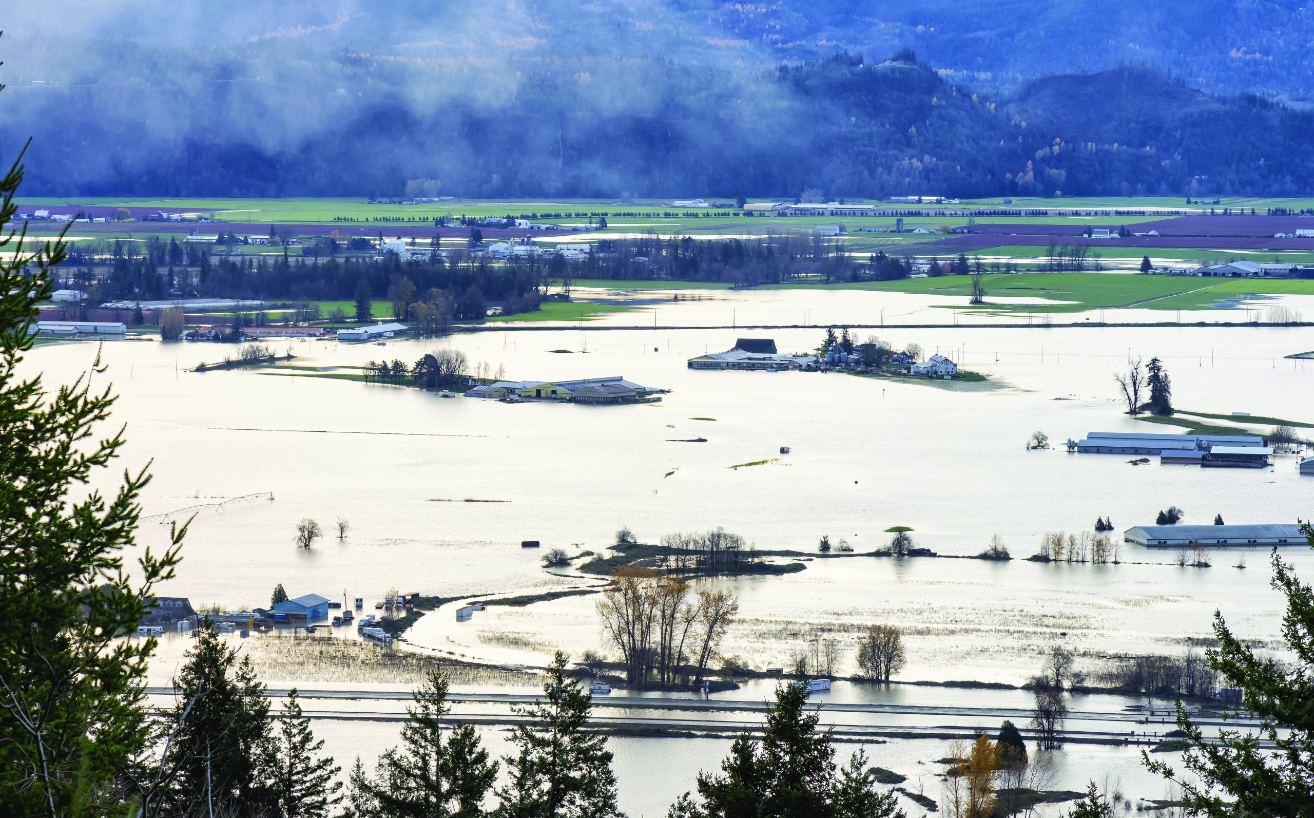 Devestating Flood and black smoke from fire in the city and farmland after storm.
